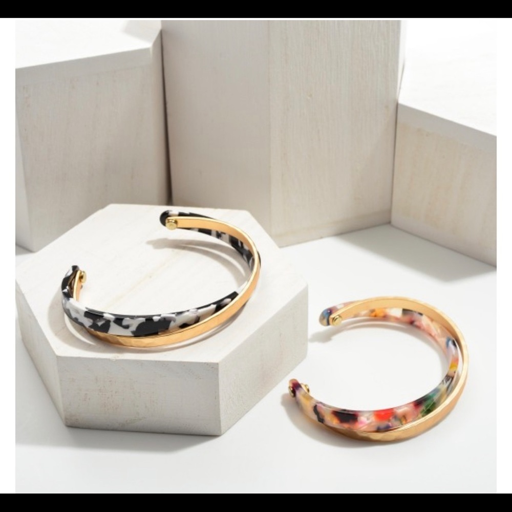 Resin cuff bracelet featuring hammered gold accents.